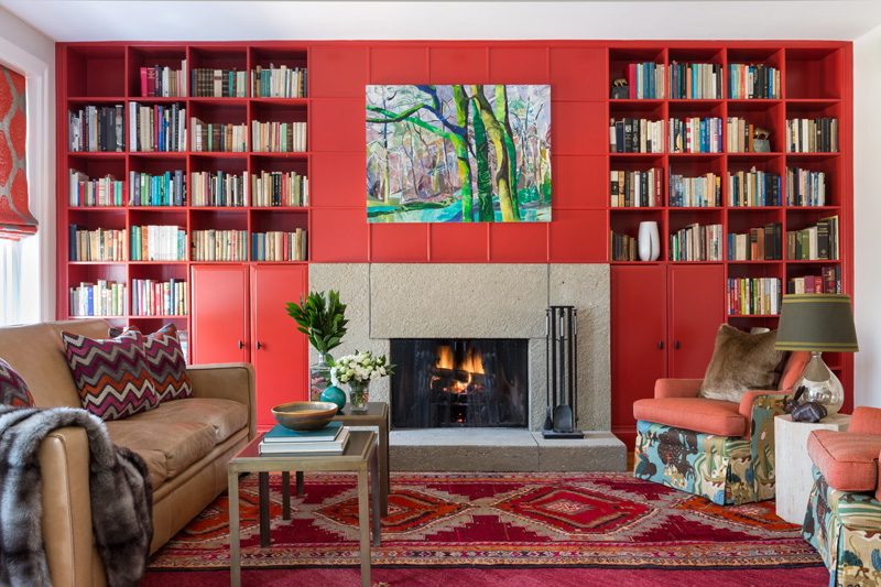 Beautiful interior design in living room with red built-ins and patterned chairs