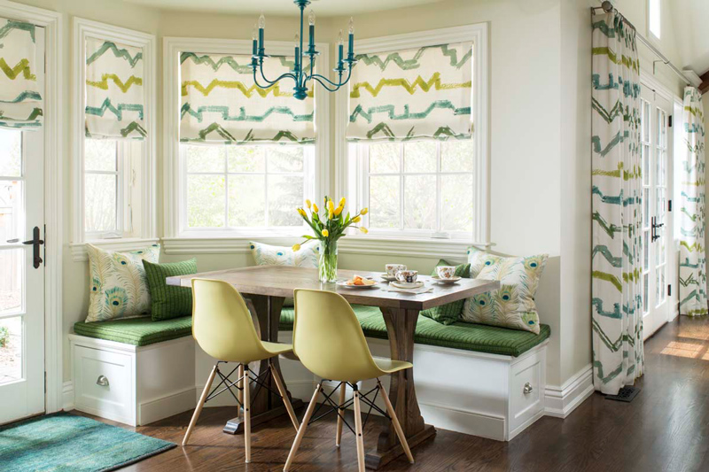 Beautiful interior design in informal dining area with bench seating and green chairs