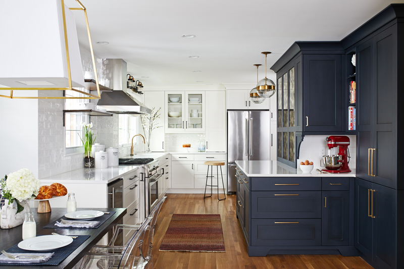 Beautiful interior design in kitchen with navy cabinets and gold finishings